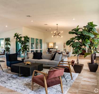 a living room with a couch and chairs and a table at Lakeside Gardens, Daytona Florida