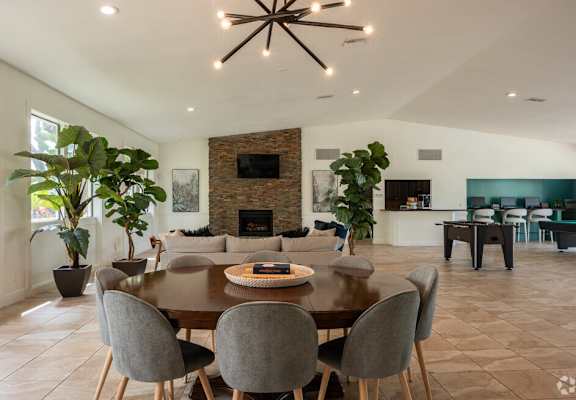 a dining room and living room with a table and chairs at Lakeside Gardens, Daytona Florida