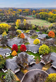 A suburban neighborhood with houses and trees in autumn colors.