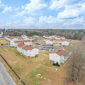 an aerial view of a neighborhood with houses and a road