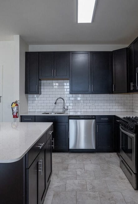 a kitchen with stainless steel appliances and a marble counter top at The Collings at the Lumberyard, Collingswood, 08108