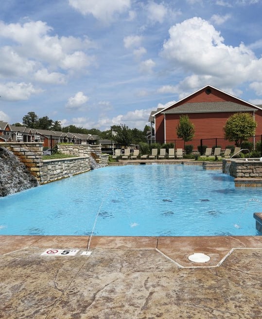 a swimming pool with a building in the background