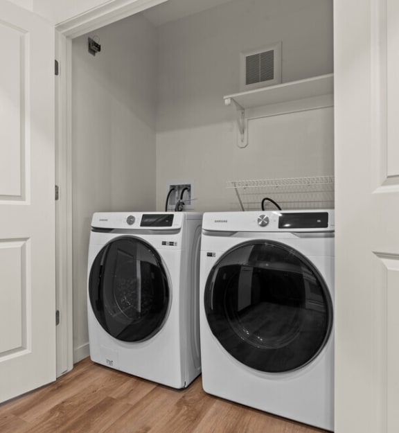 the laundry room in a home with two washing machines