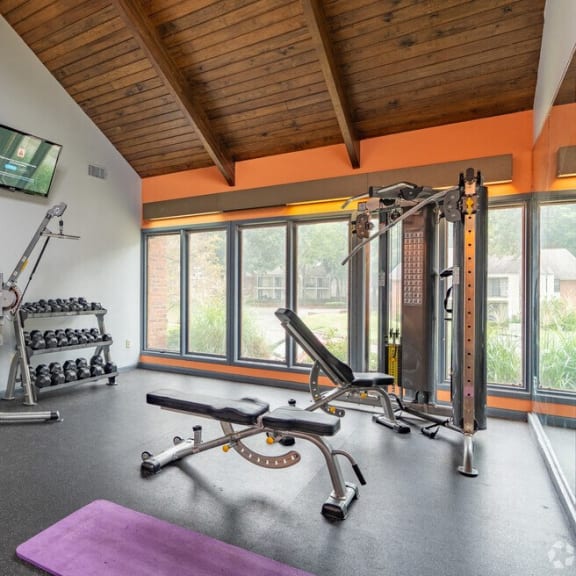 a home gym with exercise equipment and a window