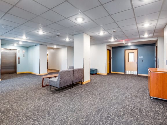 a large room with a couch and a table and a door