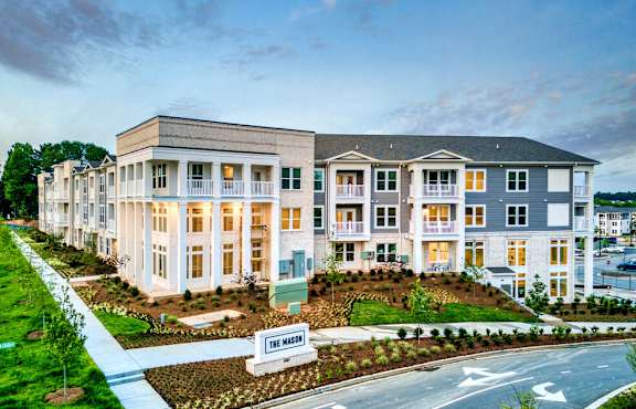 A row of townhouses with a sign that says "The Mills".