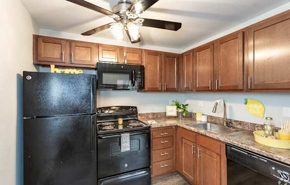 A kitchen with a black fridge and stove.