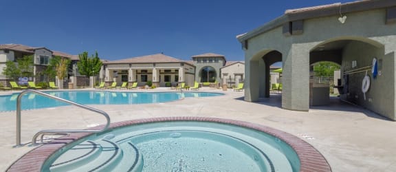 Pool with lounge chairs l The Trails at Pioneer Meadows Apartments in Sparks NV