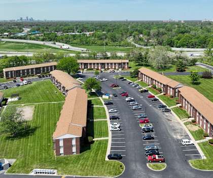 an aerial view of a campus with cars parked in a parking lot