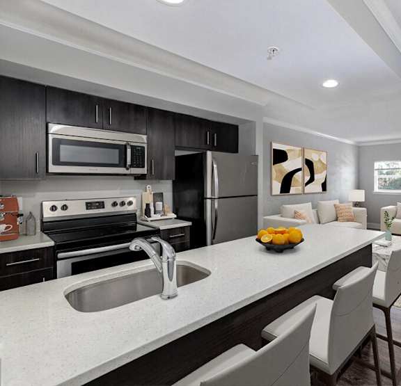 a kitchen and living room with a large counter and a sink