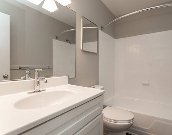 a bathroom with a sink toilet and a tub