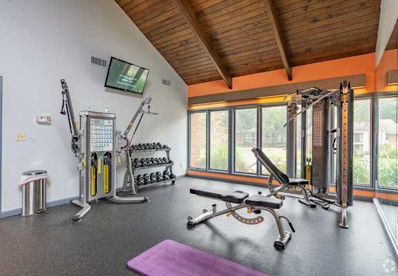 a home gym with exercise equipment and a window