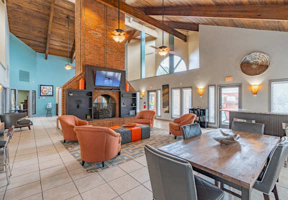 a living room with a table and chairs and a fireplace