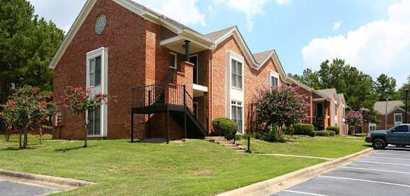 A brick building with a black gate in front.