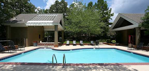 A pool with a metal grate in the middle of it.