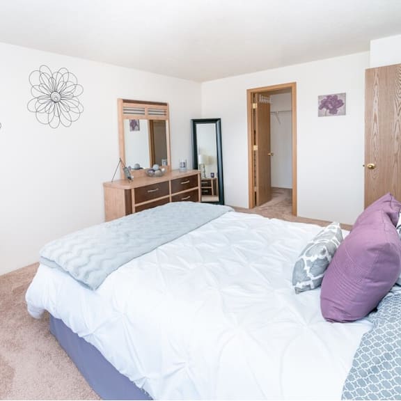 a bedroom with a large bed and a couch
