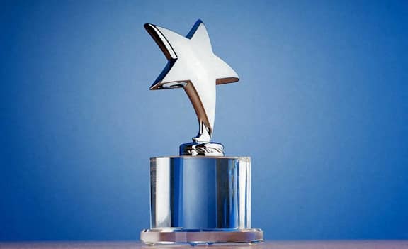 a silver trophy with a star on top of it