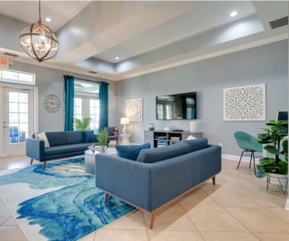 a living room with blue couches and a blue rug