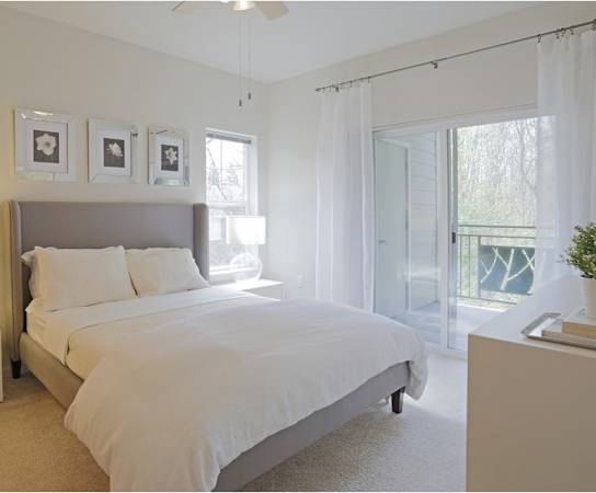 Bedroom with large bed and night stand at Wilsonville Summit Apartments, Wilsonville , 97070