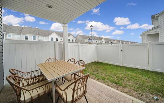 A patio with a table and chairs is shown.