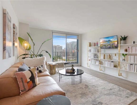 a living room with a leather couch and a large window