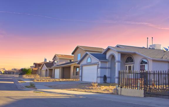 A row of houses with a street in front.