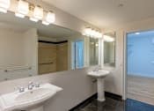Thumbnail 73 of 74 - A bathroom with a white sink and mirror.