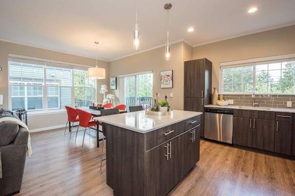 Latitude Apartments and Townhomes in Happy Valley, Oregon Model Kitchen with Island and Dining Area