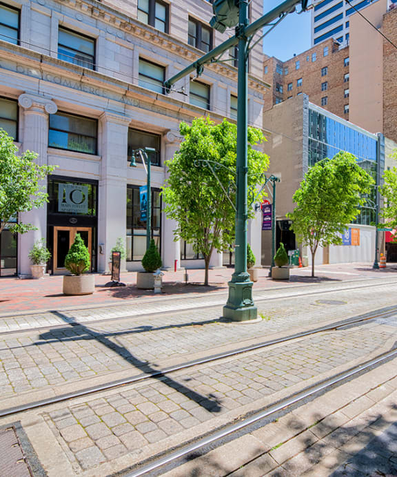 a city street with a train track in the middle of it