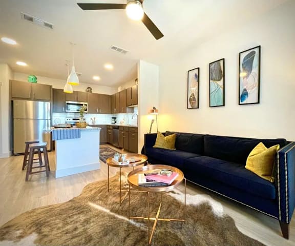 a living room and kitchen with a couch and a table