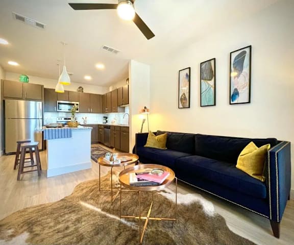 a living room and kitchen with a couch and a table