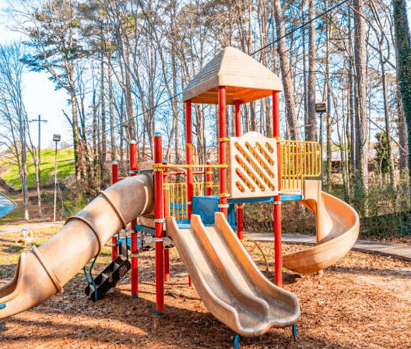 a playground with slides and a swing set