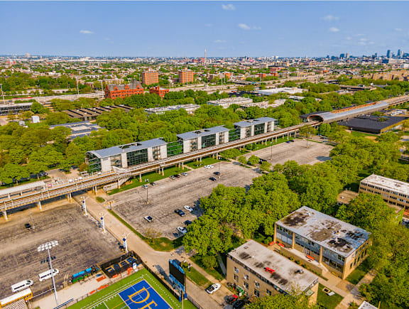 A view of a city from above, with a basketball court in the foreground.