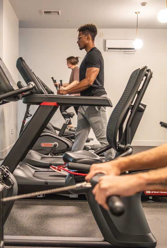 A man is working out on a treadmill in a gym.
