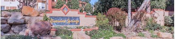 a garden with rocks and flowers in front of a house at Riverview Springs, Oceanside