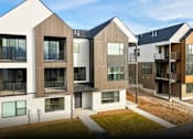 Thumbnail 1 of 9 - A modern residential area with houses having different designs.