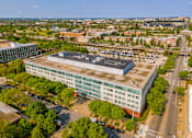 Thumbnail 46 of 59 - A large building with a parking lot in front of it.