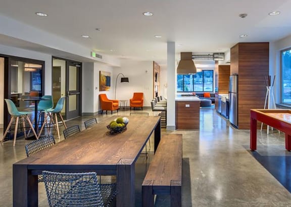 a kitchen and dining room with a wooden table and chairs