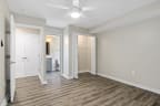 a bedroom with hardwood flooring and a ceiling fan