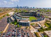 Thumbnail 53 of 59 - A large stadium with a parking lot in front of it.