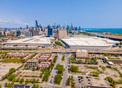 Thumbnail 47 of 59 - A cityscape with a large building in the foreground and a skyline in the background.