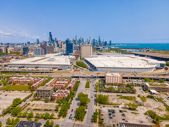 A cityscape with a large building in the foreground and a skyline in the background.