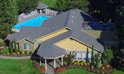 A large house with a pool in the backyard. at Commons at Avalon Park Apartments, Tigard, OR, 97224