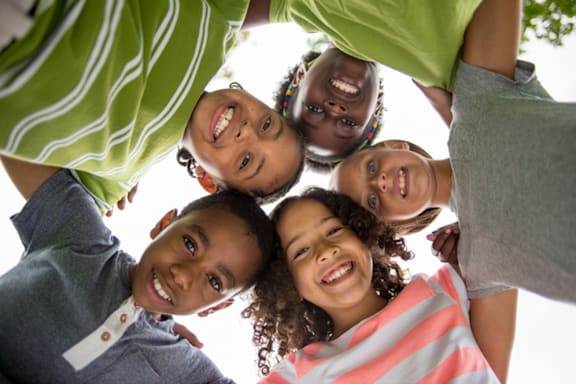 A group of children are standing in a circle at The Crawford Apartments, Roseville, CA, 95747