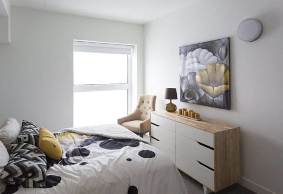 a bedroom with a bed and a dresser