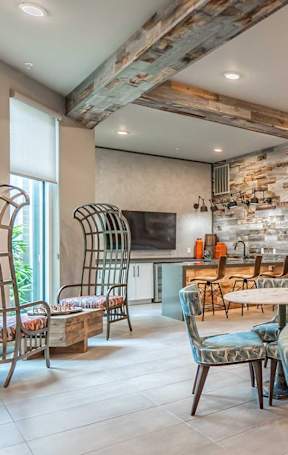 A living room with a stone wall and a fireplace.