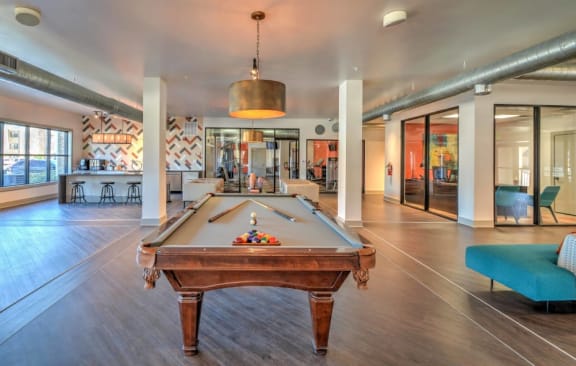 a pool table in a living room with a bar at The Atlantic McKinney Ranch, Texas