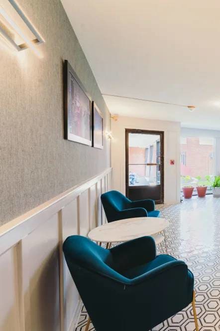 a lobby with chairs and a counter in a building at Five High, West Hartford, CT, 06119