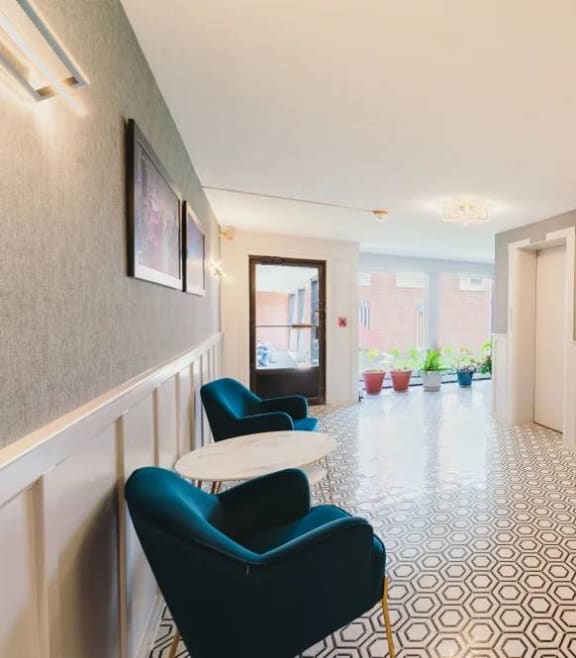 a lobby with chairs and a counter in a building at Five High, West Hartford, CT, 06119
