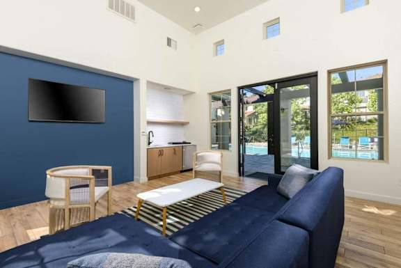 a living room with a blue couch and a tv at Mission Hills, California, 93012